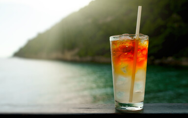 Glass of Mai Tai cocktail in front of the sea background.