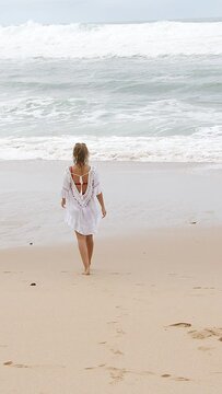 Walk over a sandy beach - sexy girl on holiday - travel photography