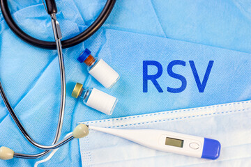 RSV letters with different medical equipment aside on light blue background. Respiratory Syncytial Virus disease concept.