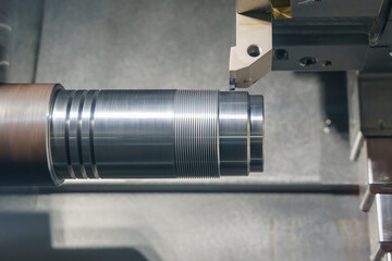 The CNC lathe machine thread cutting at the metal shaft parts. - obrazy, fototapety, plakaty