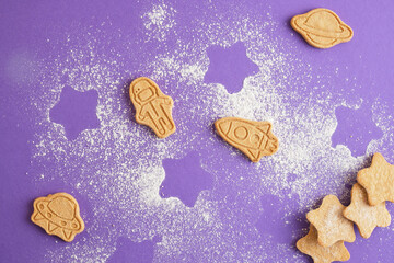 Cookies, stars and astronaut for world cosmonautics day. cookies on purple background. Space and astronomy concept