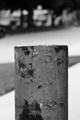 A typical metal fence post in a black and white.