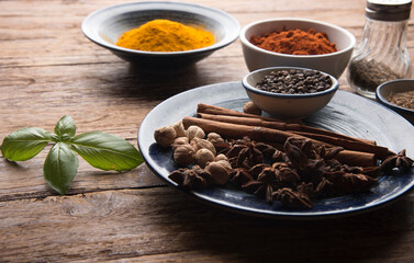 pices and herbs on old kitchen table. Food and cuisine ingredients.