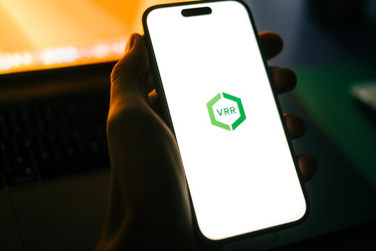 Verkehrsverbund Rhein-Ruhr logo, man using VRR app on smartphone. D&uuml;sseldorf, Germany. 4 January 2023