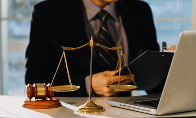 Business and lawyers discussing contract papers with brass scale on desk in office. Law, legal...
