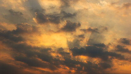 sunset orange beam sky background with white clouds cumulus floating soft focus, copy space.