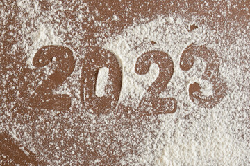 silhouette of flour figures 2023 on brown background
