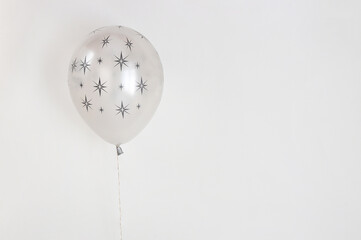 Children's balloon on a light background. Stars are drawn on the balloon.