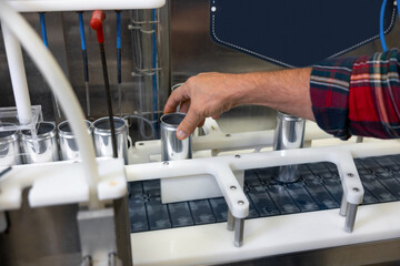 Skilled production worker using modern beer canning equipment