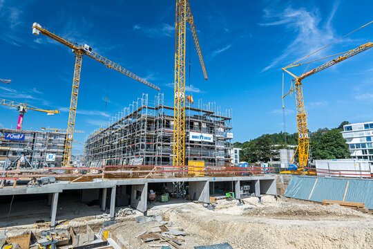 Construction site with foundations and cranes on a sunny day in Tübingen, Germany (editorial)