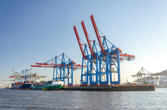 Container vessels and harbour facilities at a the Burchardkai container terminal in the port area of Hamburg, Germany