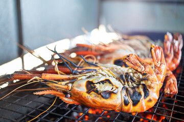 Cooking king prawns grilled on the flaming grill