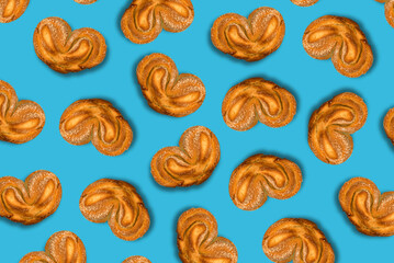 Pattern of fresh sweet buns, baking on blue background top view
