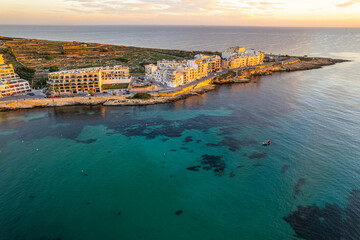 Marsaskala village and seascape, Malta at sunrise. Aerial Drone view