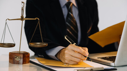 Business and lawyers discussing contract papers with brass scale on desk in office. Law, legal...