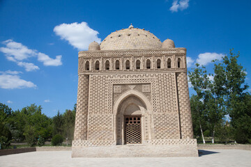 Samanid stone mausoleum in a park in Bukhara, Uzbekistan. Tourism, travel concept.