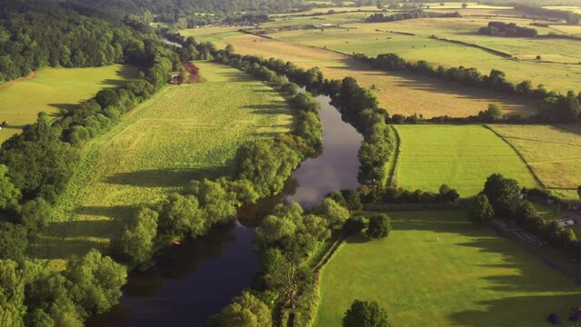 Beautiful winding river aerial view through British countryside