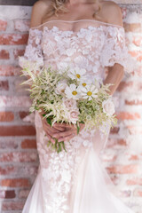 Very beautiful wedding bridal bouquet, made of white roch and daisies,