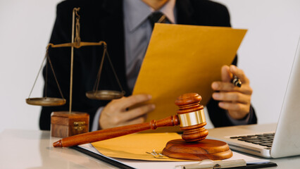 Business and lawyers discussing contract papers with brass scale on desk in office. Law, legal...