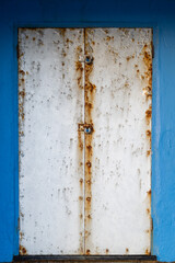Blue beach hut with silver metal doors at Bexhill-on-Sea, East Sussex, England