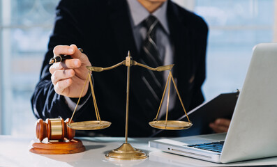 Business and lawyers discussing contract papers with brass scale on desk in office. Law, legal...
