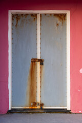 Pink beach hut with silver metal doors at Bexhill-on-Sea, East Sussex, England