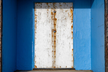 Blue beach hut with silver metal doors at Bexhill-on-Sea, East Sussex, England