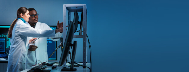 Group of microelectronic engineers discussing in a modern microprocessor manufacture lab. Workplace...