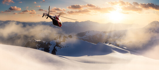 Helicopter flying over the Rocky Mountains during a colorful sunset. Aerial Landscape from BC,...