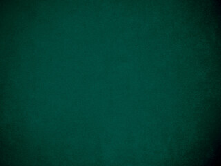 Dark green velvet fabric texture used as background. Tone color green cloth  background of soft and smooth textile material. There is space for text and for all types of design work..