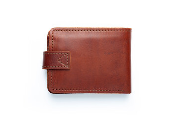 Brown leather wallet on a button on a white background. Top view.