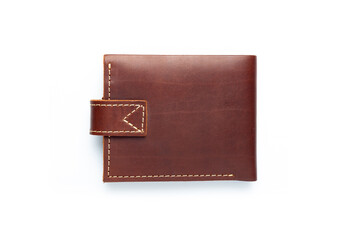 Brown leather wallet on a button on a white background. Top view.