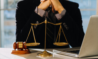 Business and lawyers discussing contract papers with brass scale on desk in office. Law, legal...