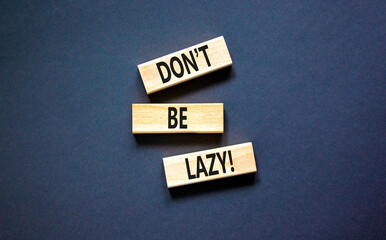 Motivational and do not be lazy symbol. Concept words Do not be lazy on wooden blocks on a beautiful black table black background. Business do not be lazy concept. Copy space.