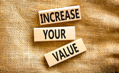 Increase your value symbol. Concept words Increase your value on wooden blocks on a beautiful canvas table canvas background. Business increase your value concept. Copy space.