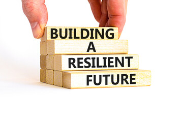 Building a resilient future symbol. Concept word Building a resilient future on wooden blocks. Beautiful white table white background. Business and building a resilient future concept. Copy space.