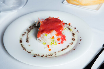 Shredded cod dish with tomato sauce and escarole. Traditional Spanish tapa salad.