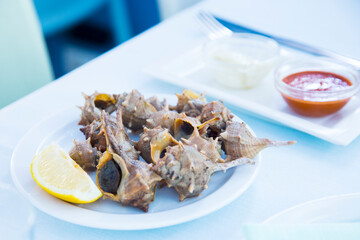 Grilled sea snails in a Spanish tapas restaurant.