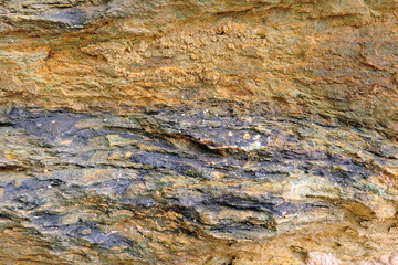 A brown and orange sedimentary rock containing sulfur and pyrite