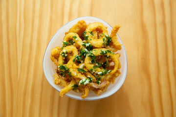 Chocos. Diced and battered squid served with lemon. Traditional Spanish tapa recipe.