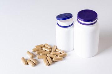 Mockup bottles with natural bio pills or vitamins, white backgro