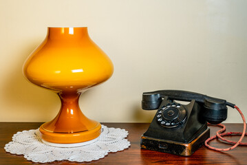 Interior. VVntage phone and lamp on wooden table.