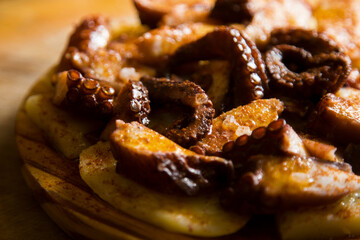 Pulpo a la Gallega. Octopus cooked with boiled potato, paprika and olive oil. Galician octopus recipe north of Spain tapa.