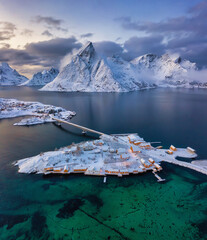 Winter aerial panorama snowy mountains and village in the arctic fjords, Norway, Lofoten islands