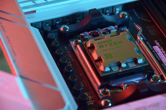 Close-up of an AMD Ryzen 9 3900X processor installed on a motherboard ASUS ROG STRIX X670E