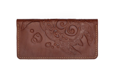 Big brown leather wallet on a button on a white background, turtle print. Top view