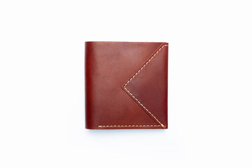 Small brown leather wallet on a button on a white background. Top view