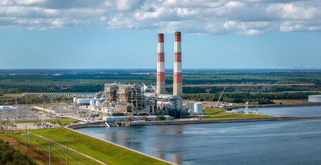 Obraz premium Power Plant in West Coast, Florida with St. Petersburg city skyline visible in the background. Jan 3, 2022