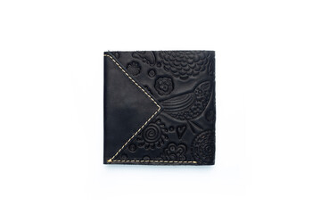 Small black leather wallet on a button on a white background, birds print. Top view