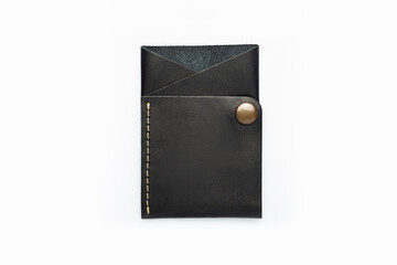 Black leather wallet on a button on a white background. Card holder. Top view